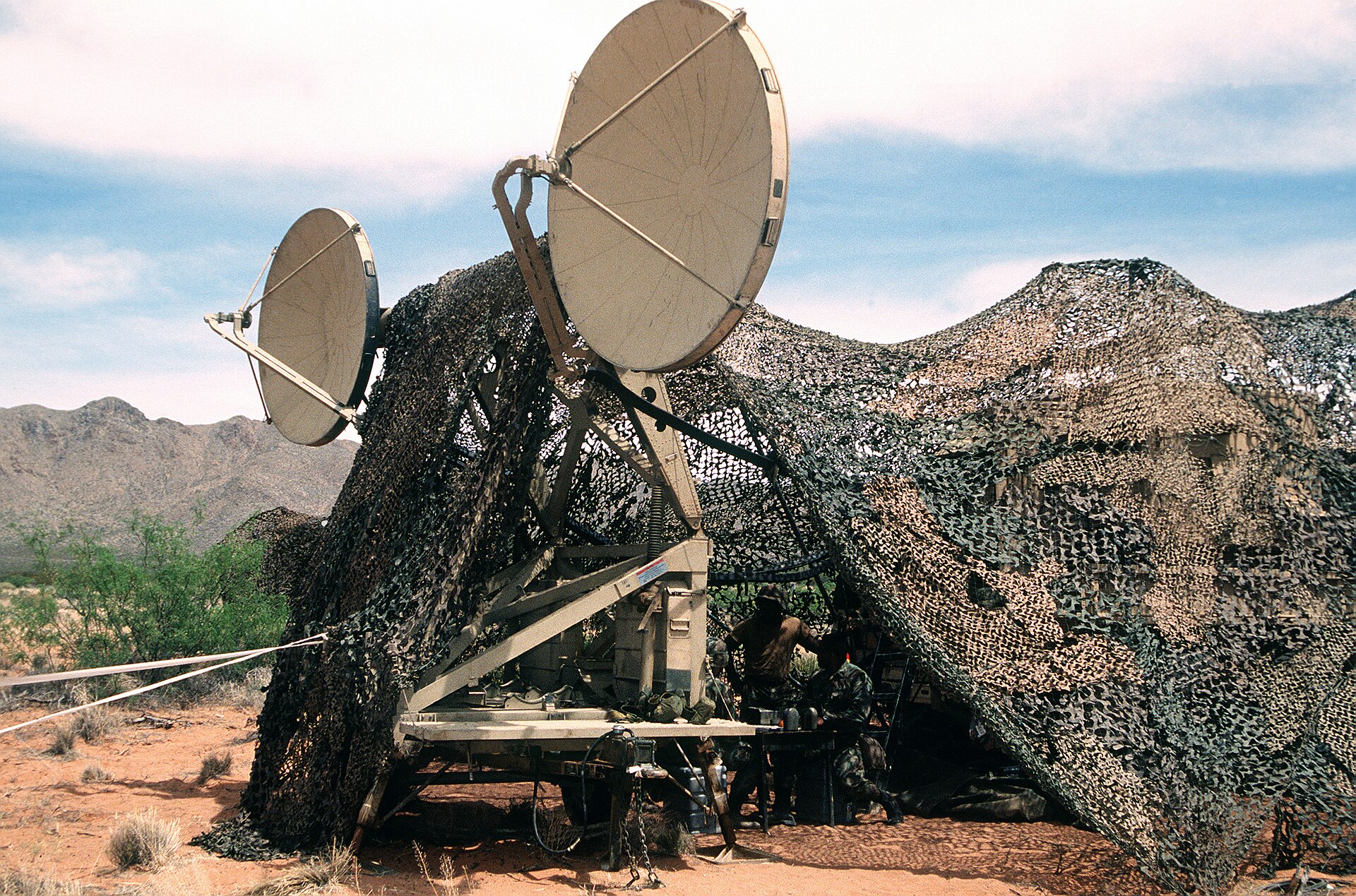 Conjunto de antenas planas alineadas sobre una estructura metálica al aire libre bajo cielo despejado